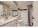 A well-lit bathroom with a shower-tub combo, neutral accents, and ample counter space at 6410 Silver Mesa Dr # B, Highlands Ranch, CO 80130