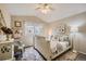 Comfortable bedroom with floral area rug, chair, and large window with natural light, perfect for relaxation at 6410 Silver Mesa Dr # B, Highlands Ranch, CO 80130