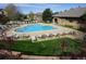 The community pool is surrounded by lounge chairs and grassy spots, providing ample space for residents at 6410 Silver Mesa Dr # B, Highlands Ranch, CO 80130