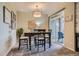 Cozy dining room with a modern chandelier, seating for four, and sliding glass doors leading to patio at 6410 Silver Mesa Dr # B, Highlands Ranch, CO 80130