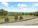 Scenic golf course view with lush green fairways and mature trees, seen from behind a metal fence at 6410 Silver Mesa Dr # B, Highlands Ranch, CO 80130