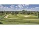 Expansive view of a golf course with mature trees, sand traps and mountain views in the distance at 6410 Silver Mesa Dr # B, Highlands Ranch, CO 80130