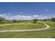 Scenic view of a golf course with lush greenery, sand traps, and blue skies, offering a beautiful recreational setting at 6410 Silver Mesa Dr # B, Highlands Ranch, CO 80130