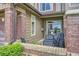 Covered patio with brick accents, outdoor seating, and grill, perfect for entertaining and enjoying the outdoors at 6410 Silver Mesa Dr # B, Highlands Ranch, CO 80130