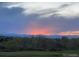 Scenic sunset view over mountains, trees, and a golf course at 6410 Silver Mesa Dr # B, Highlands Ranch, CO 80130