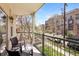 Charming balcony with seating overlooks a quiet street and lush landscaping at 1560 Milwaukee St # 240, Denver, CO 80206
