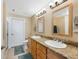 Bathroom with a double sink vanity, granite countertops, and modern fixtures at 1560 Milwaukee St # 240, Denver, CO 80206