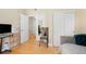 Bedroom with hardwood floors, closet, and adjacent workspace at 1560 Milwaukee St # 240, Denver, CO 80206