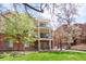 Apartment building exterior featuring multiple balconies with a lush green lawn at 1560 Milwaukee St # 240, Denver, CO 80206