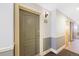 Hallway featuring neutral paint, trim, and door to unit 240 at 1560 Milwaukee St # 240, Denver, CO 80206