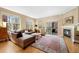 Spacious living room features a cozy fireplace, natural light, and access to an outdoor balcony at 1560 Milwaukee St # 240, Denver, CO 80206