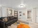 Finished basement includes a comfortable couch, exposed ceiling, recessed lighting, wood flooring, and doorway at 361 S Logan St, Denver, CO 80209