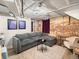 Finished basement features a brick wall, recessed lighting, wood flooring, and a comfortable sectional at 361 S Logan St, Denver, CO 80209