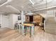 Finished basement with brick wall, an exposed ceiling, recessed lighting, wood flooring, and a comfortable seating area at 361 S Logan St, Denver, CO 80209
