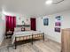 Finished basement bedroom includes exposed ceiling, wood flooring, bed, decorations, and two windows at 361 S Logan St, Denver, CO 80209