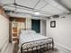 Finished basement bedroom includes exposed brick, recessed lighting, wood flooring, bed, and decorations at 361 S Logan St, Denver, CO 80209