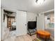View into a finished basement bedroom, includes exposed brick, recessed lighting, wood flooring, and doorway at 361 S Logan St, Denver, CO 80209