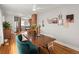 Bright dining area featuring hardwood floors, stylish decor, and seamless flow to kitchen at 361 S Logan St, Denver, CO 80209