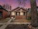 Charming brick home with a cozy front porch and well-maintained yard at sunset at 361 S Logan St, Denver, CO 80209