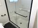 Clean walk-in shower with white tile and black accents at 363 Helena Cir, Lone Tree, CO 80124