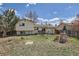 Spacious backyard featuring a patio area, grassy lawn, and mature trees at 2155 S Lewiston St, Aurora, CO 80013