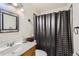 Functional bathroom featuring a vanity sink, toilet, and shower with curtain at 2155 S Lewiston St, Aurora, CO 80013