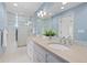 Charming bathroom featuring double vanity, granite counters, and a glass-enclosed shower at 1325 Jackson St, Denver, CO 80206