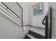 Bright entryway with hardwood floors, modern railing and door with sidelight windows providing natural light at 1325 Jackson St, Denver, CO 80206