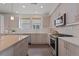 Modern kitchen features white countertops, light cabinetry, stainless steel appliances, and ample natural light at 1325 Jackson St, Denver, CO 80206