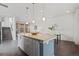 Modern kitchen with an island and dining area showcasing a seamless flow into a bright living space at 1325 Jackson St, Denver, CO 80206