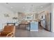 Bright, modern kitchen featuring stainless steel appliances, light wood cabinets, and a central island with seating at 1325 Jackson St, Denver, CO 80206