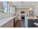 Modern kitchen with stainless appliances, sleek countertops, and light wood cabinets, perfect for cooking and entertaining at 1325 Jackson St, Denver, CO 80206