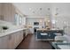 Contemporary kitchen with stainless steel appliances, light wood cabinetry, and an island for food preparation and dining at 1325 Jackson St, Denver, CO 80206