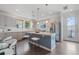 Modern kitchen with stainless steel appliances, white countertops, and a central island with seating for casual dining at 1325 Jackson St, Denver, CO 80206
