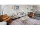 Comfortable living room with neutral sofa, stylish chairs, and a decorative area rug at 1325 Jackson St, Denver, CO 80206