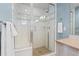 Modern bathroom shower featuring sleek glass doors, tiled walls, and contemporary fixtures at 1325 Jackson St, Denver, CO 80206
