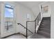 Modern staircase with black metal railings, hardwood steps, and natural light at 1325 Jackson St, Denver, CO 80206