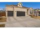 Two-story brick home with a 3-car garage and mature trees at 8121 E 132Nd Ave, Thornton, CO 80602