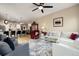 Open living room with a view into the kitchen, fireplace, and comfortable seating at 8121 E 132Nd Ave, Thornton, CO 80602