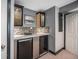 Basement wet bar with tile backsplash, wine fridge, and glass front cabinetry for ample storage at 1811 Hogan Ct, Castle Rock, CO 80109