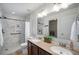 Bathroom with double sinks, granite countertops, walk-in shower, and neutral tones at 1811 Hogan Ct, Castle Rock, CO 80109