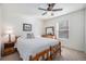 Comfortable bedroom with a ceiling fan, soft carpet, and a wooden bed frame beneath a window at 1811 Hogan Ct, Castle Rock, CO 80109