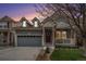 Charming two-story home with a covered front porch, grey siding, a well-kept lawn and an attached garage at 1811 Hogan Ct, Castle Rock, CO 80109