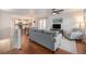 Bright living room with hardwood floors, comfortable seating, and open layout to the kitchen and dining area at 1811 Hogan Ct, Castle Rock, CO 80109