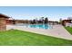 Community pool and sundeck with pool house surrounded by green space at 1811 Hogan Ct, Castle Rock, CO 80109