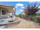 Lovely backyard with a retaining wall and rock landscaping featuring mature trees and greenery at 22669 E Tufts Pl, Aurora, CO 80015