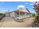 Charming backyard with a covered patio, retaining wall, rock landscaping, and a privacy fence at 22669 E Tufts Pl, Aurora, CO 80015