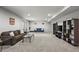 Spacious basement with a cozy seating area, a large television, and neutral-colored carpeting at 22669 E Tufts Pl, Aurora, CO 80015