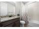 Bathroom featuring a granite countertop, a tub with shower, and decorative floral shower curtain at 22669 E Tufts Pl, Aurora, CO 80015