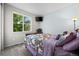 Bright bedroom with a large window and a mounted television over a small dresser at 22669 E Tufts Pl, Aurora, CO 80015
